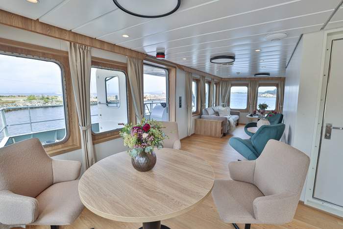 MV Vikingfjord Lounge Wide with Table Stern View Secret Atlas.jpg